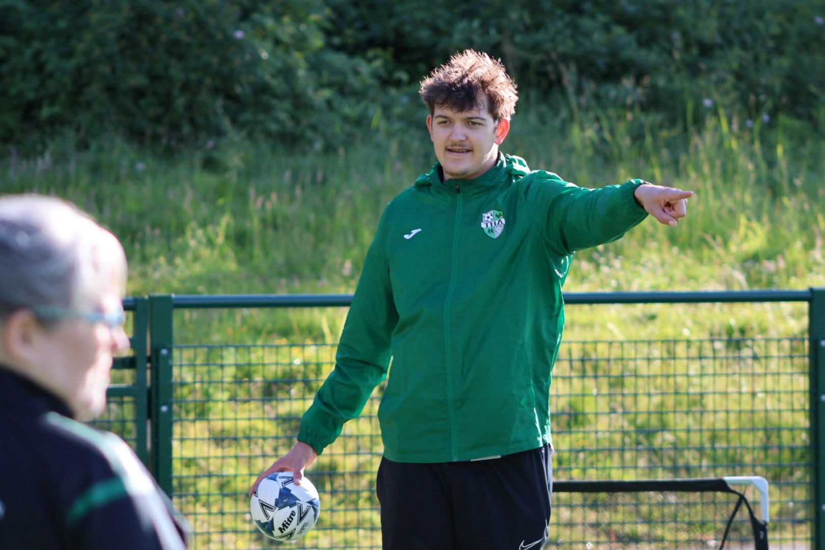 THA coach guiding a football session