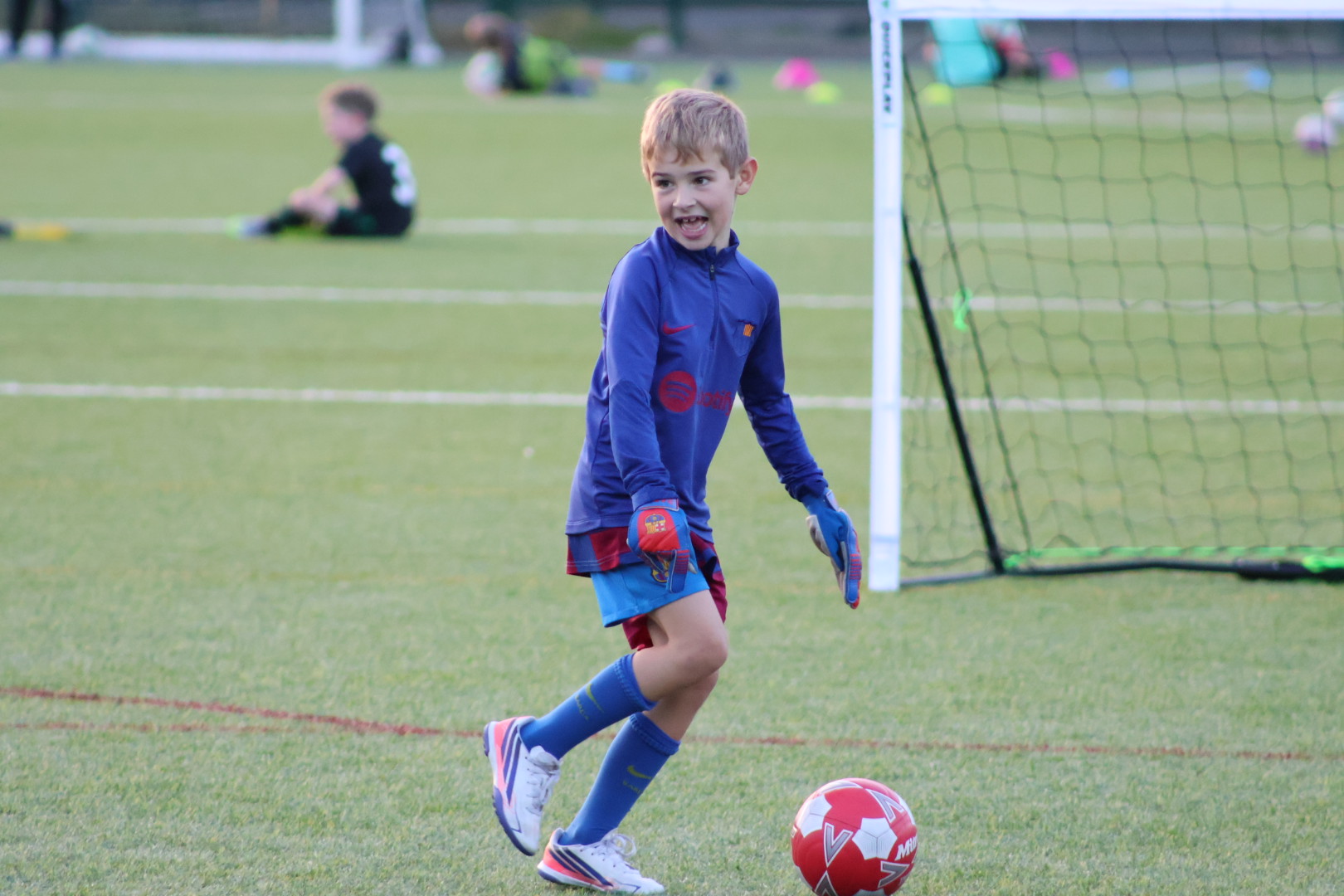 Children playing football on a pitch